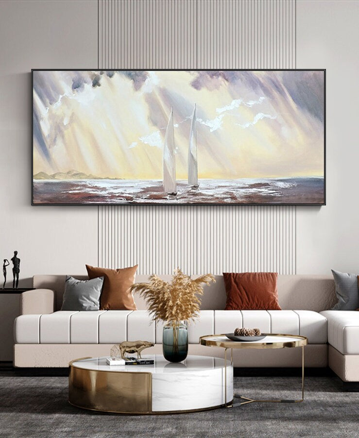 May include: A painting of two white sailboats on a body of water with a yellow and purple sky. The sky is filled with clouds and rays of light. The painting is framed in a black frame.