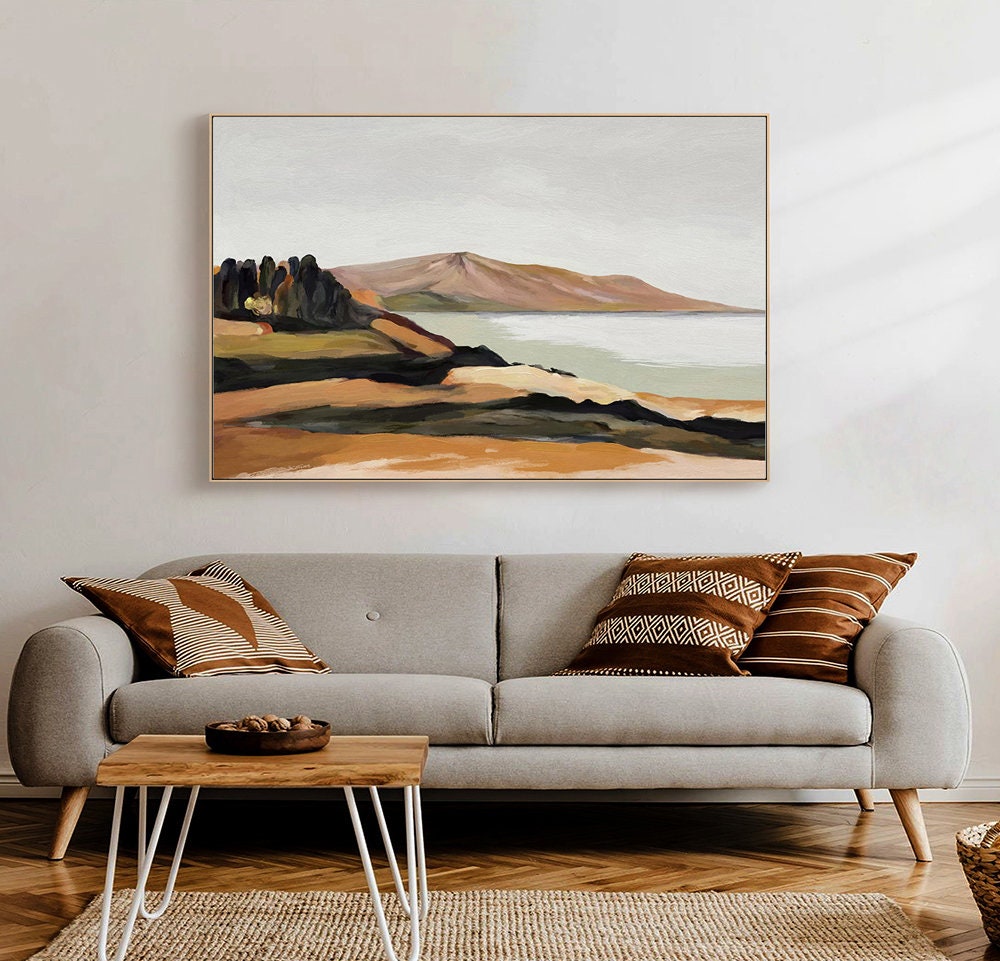 May include: A painting of a landscape with a mountain range, a body of water, and a small group of trees in the foreground. The painting is done in a muted color palette of browns, greens, and blues.