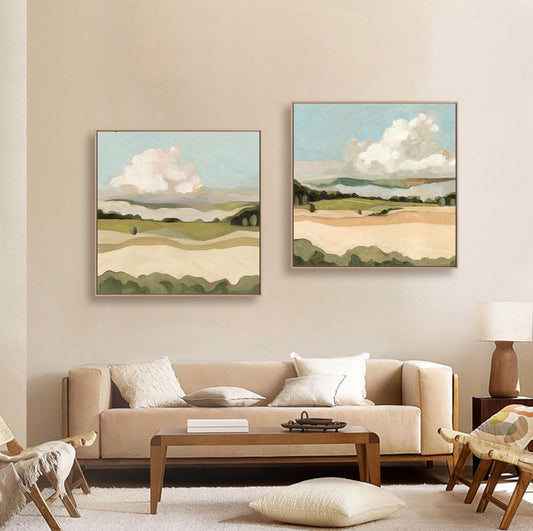 May include: Two framed landscape paintings with a green and brown color scheme. The paintings depict a rolling countryside with a large white cloud in the sky.