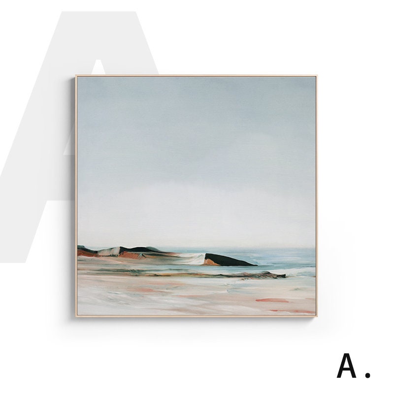 May include: A framed abstract painting of a seascape with a light blue sky, a sandy beach, and a dark green and brown rocky shoreline. The painting has a minimalist style and a calming color palette.