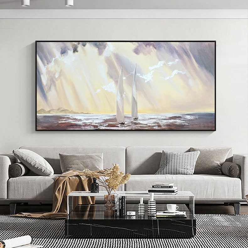 May include: A painting of two sailboats on a calm sea with a cloudy sky. The sun is shining through the clouds, creating a golden glow on the water. The sailboats are white and have a brown mast. The painting is framed in a black frame.