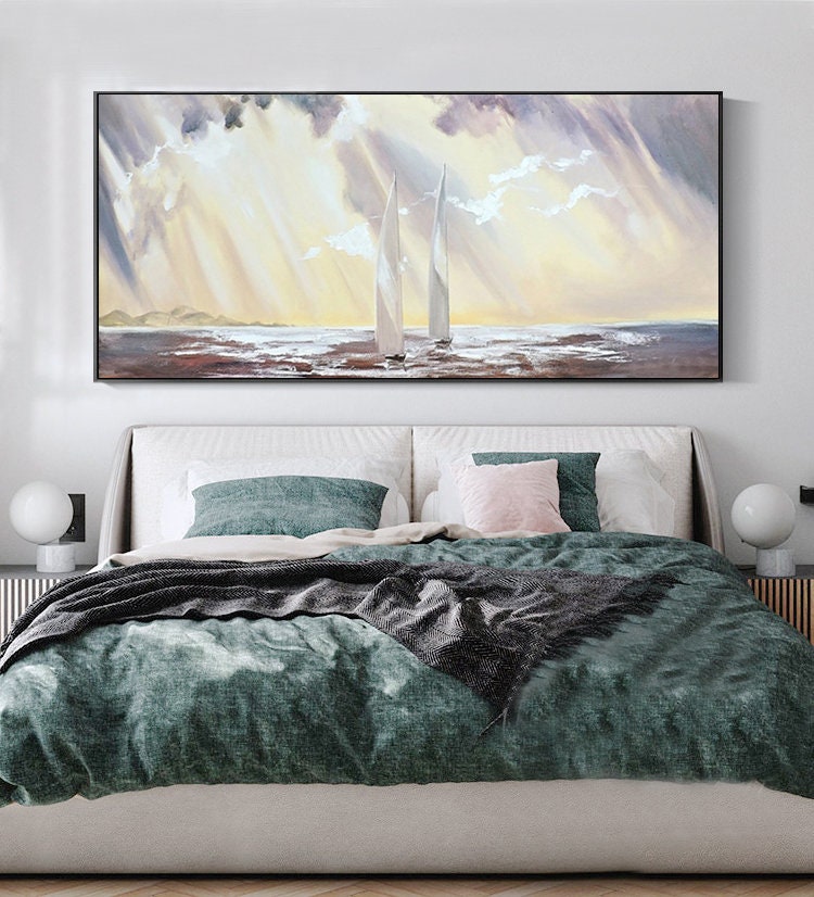 May include: A painting of two white sailboats on a body of water with a cloudy sky and sunbeams shining through the clouds.