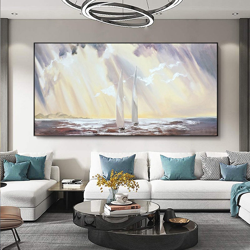 May include: A painting of two white sailboats on a body of water with a cloudy sky. The sky is a light yellow with streaks of white light. The water is a light blue with a brown shoreline.