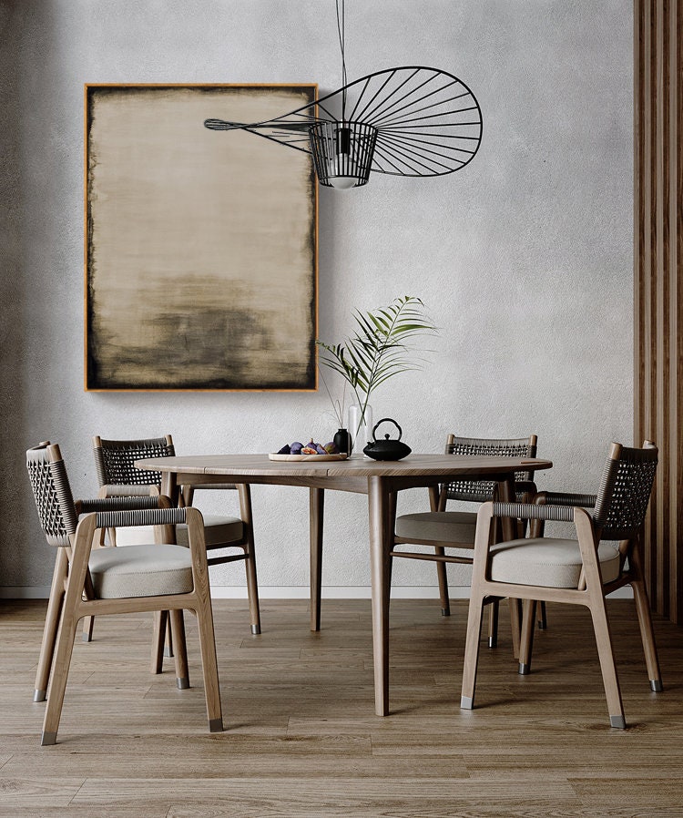 May include: A dining room table with four chairs. The table is made of wood and has a round top. The chairs are also made of wood and have woven seats. A black metal light fixture hangs above the table. A painting hangs on the wall behind the table.
