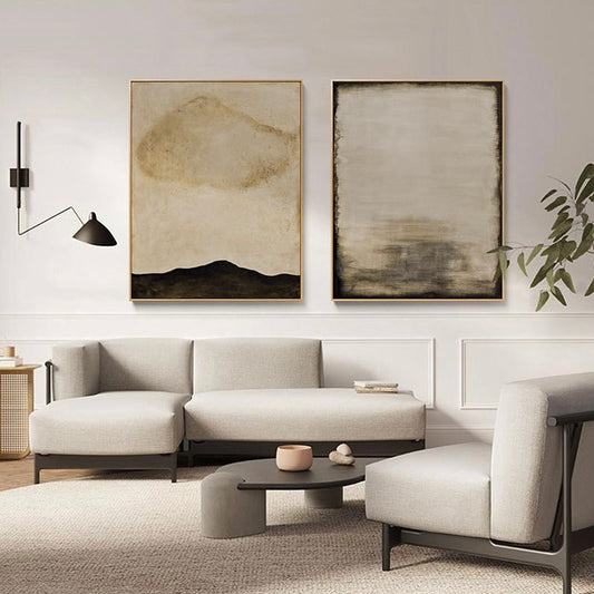 May include: Two abstract paintings in muted tones of brown and beige. The painting on the left features a dark brown mountain range with a light brown cloud shape above. The painting on the right has a light brown background with dark brown horizontal lines.