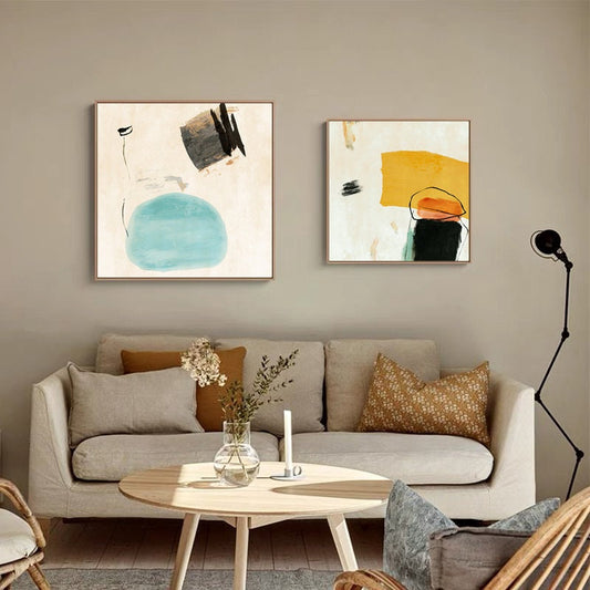 May include: Two abstract paintings with a white background and colorful shapes. The painting on the left has a blue circle and black lines. The painting on the right has a yellow rectangle and orange and black shapes.
