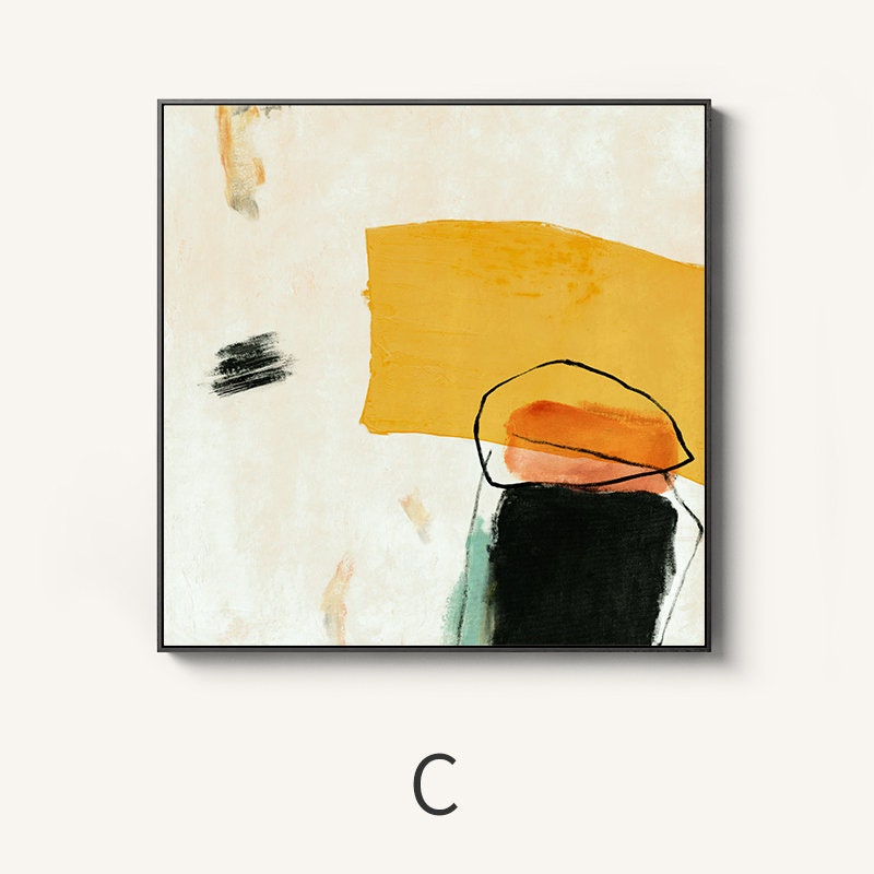 May include: Abstract painting with yellow, orange, pink, black, and green shapes on a white background. The painting is framed in black.
