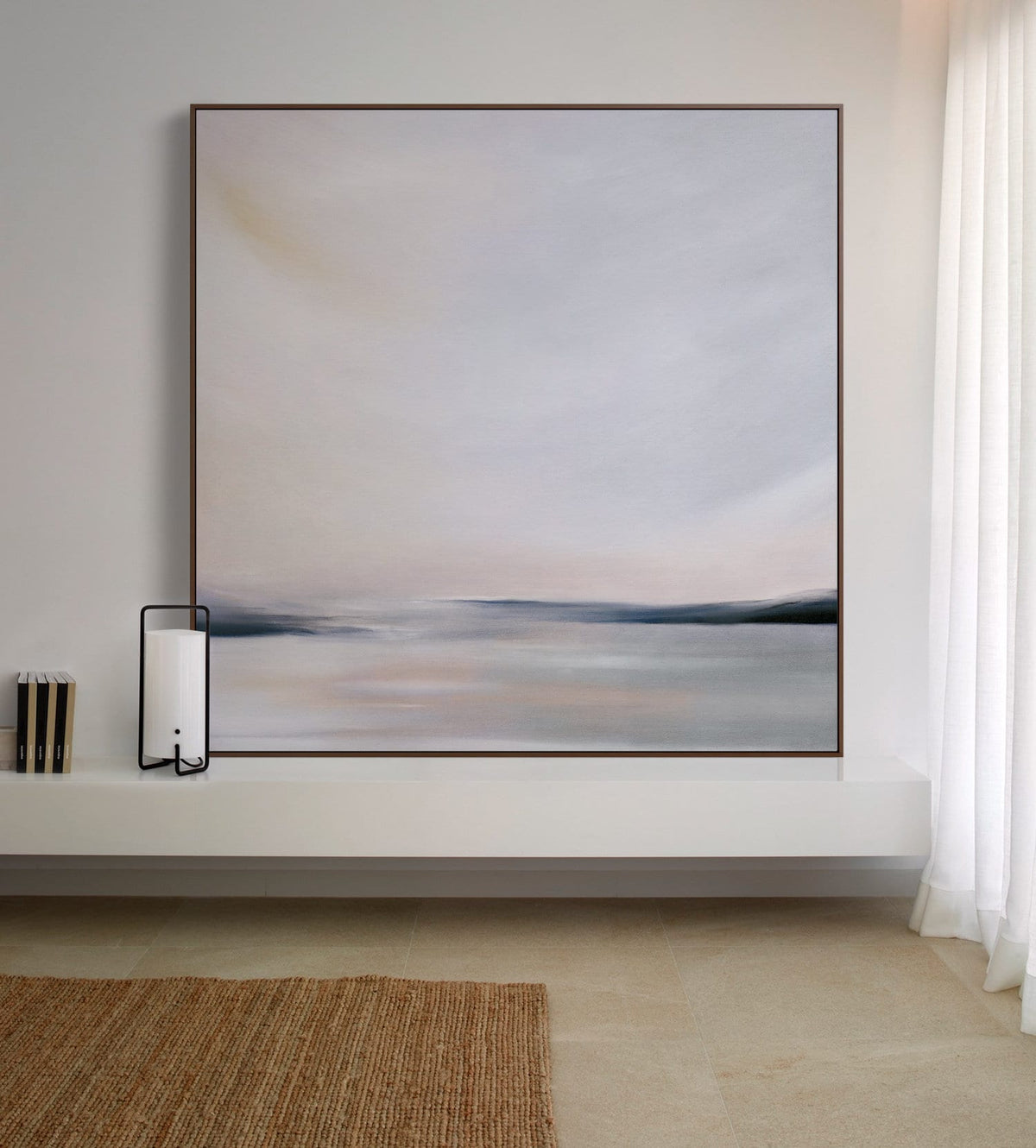May include: A framed abstract painting of a seascape with a soft, muted color palette. The painting features a horizon line with a subtle pink and blue gradient, and a hazy, atmospheric effect.
