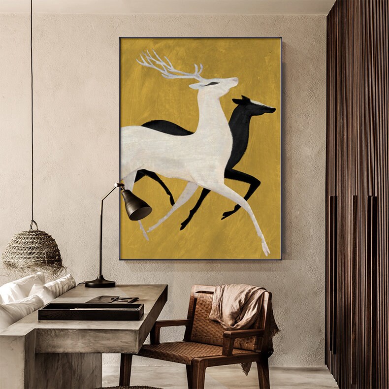 May include: A painting of two deer running on a gold background. The deer are stylized and simplified, with the front deer being white and the back deer being black.