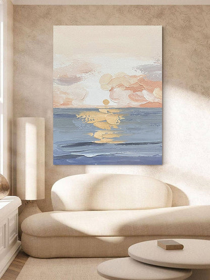 May include: Abstract painting of a sunset over the ocean. The sky is a soft pink and orange, with clouds painted in a textured style. The ocean is a deep blue, with gold highlights reflecting the setting sun.