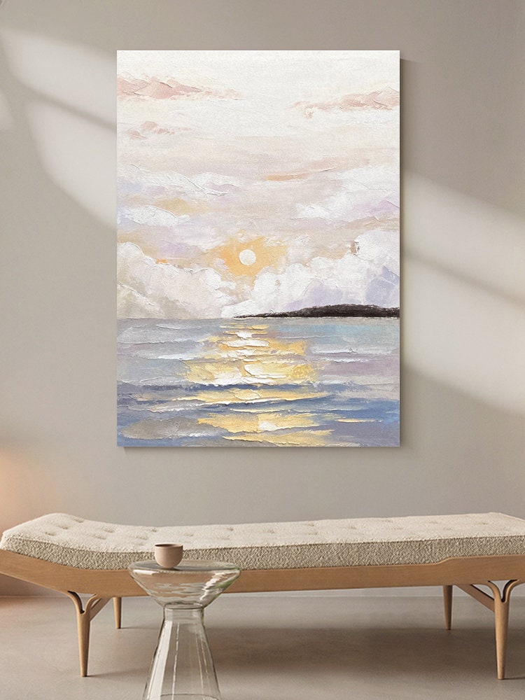 May include: A painting of a seascape with a golden sunset over the ocean. The sky is filled with fluffy white clouds and the water is a soft blue with golden reflections.