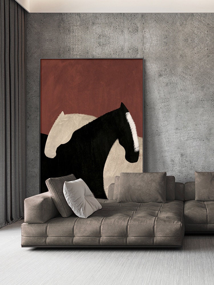 May include: Abstract painting of two horses in black and white against a red background. The painting is hanging on a wall above a brown sectional sofa.