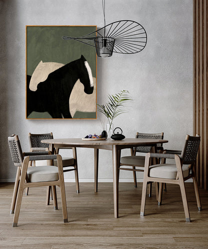 May include: A dining room with a wooden table and chairs. A painting of two horses in black and white on a green background hangs on the wall above the table. A black metal light fixture hangs from the ceiling.