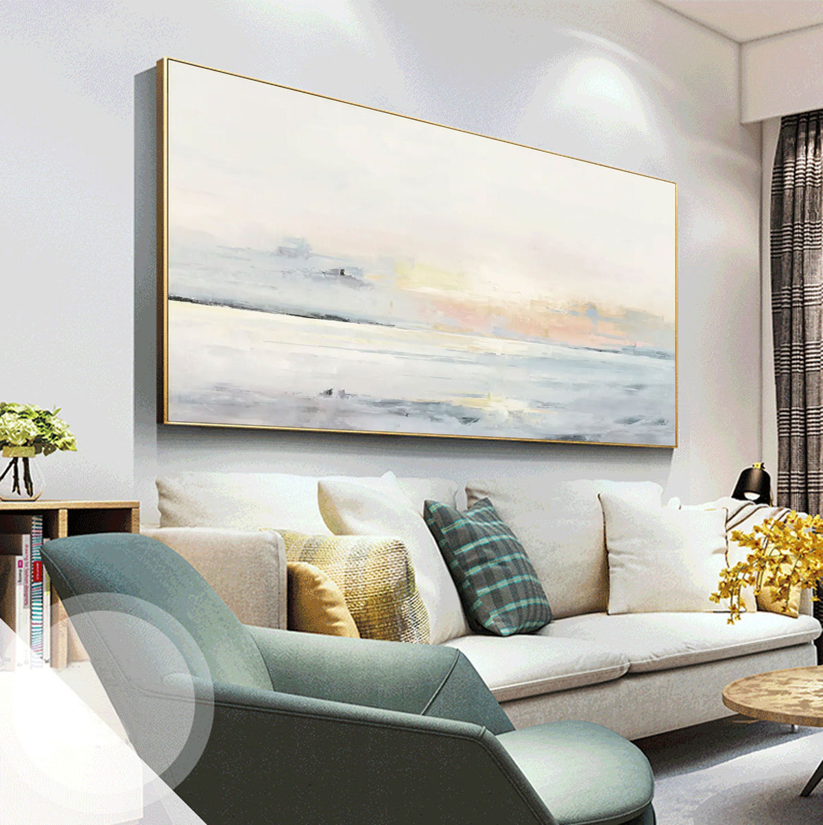 May include: A large rectangular abstract painting with a gold frame. The artwork features a soft, muted color palette of white, gray, and pale yellow, evoking a sense of calm. The painting is displayed above a white sofa with various throw pillows.