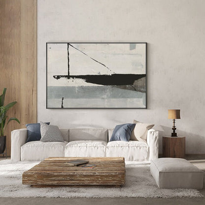 May include: A white, gray, and black abstract painting with geometric shapes hangs above a white sofa with blue and beige pillows. A wooden coffee table sits in front of the sofa, and a white ottoman sits on a fluffy white rug.