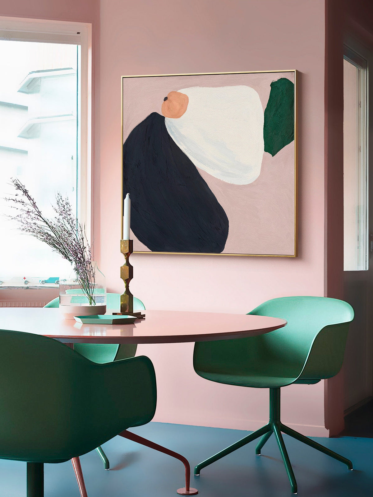 May include: A pink room with a dining table and chairs. The table is round and has a light pink surface. There are two green chairs with a swivel base. A framed abstract painting with black, white, and green shapes hangs on the wall.