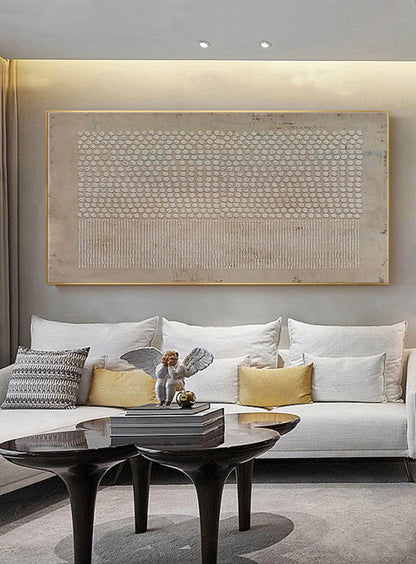 May include: A large rectangular wall art piece featuring a textured beige background with a grid of raised white dots on the upper half and a series of vertical white lines on the lower half, all enclosed within a thin gold-colored metal frame.