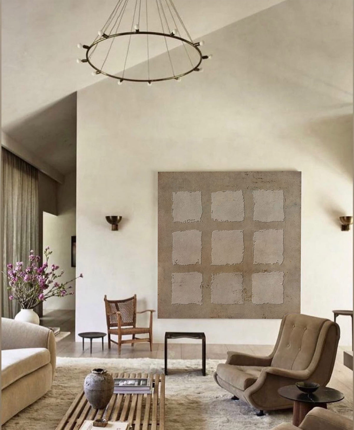 May include: A living room interior with a large abstract painting on the wall, a brown leather armchair, a wooden coffee table, and a white couch. The room is decorated in a minimalist style with neutral colors.