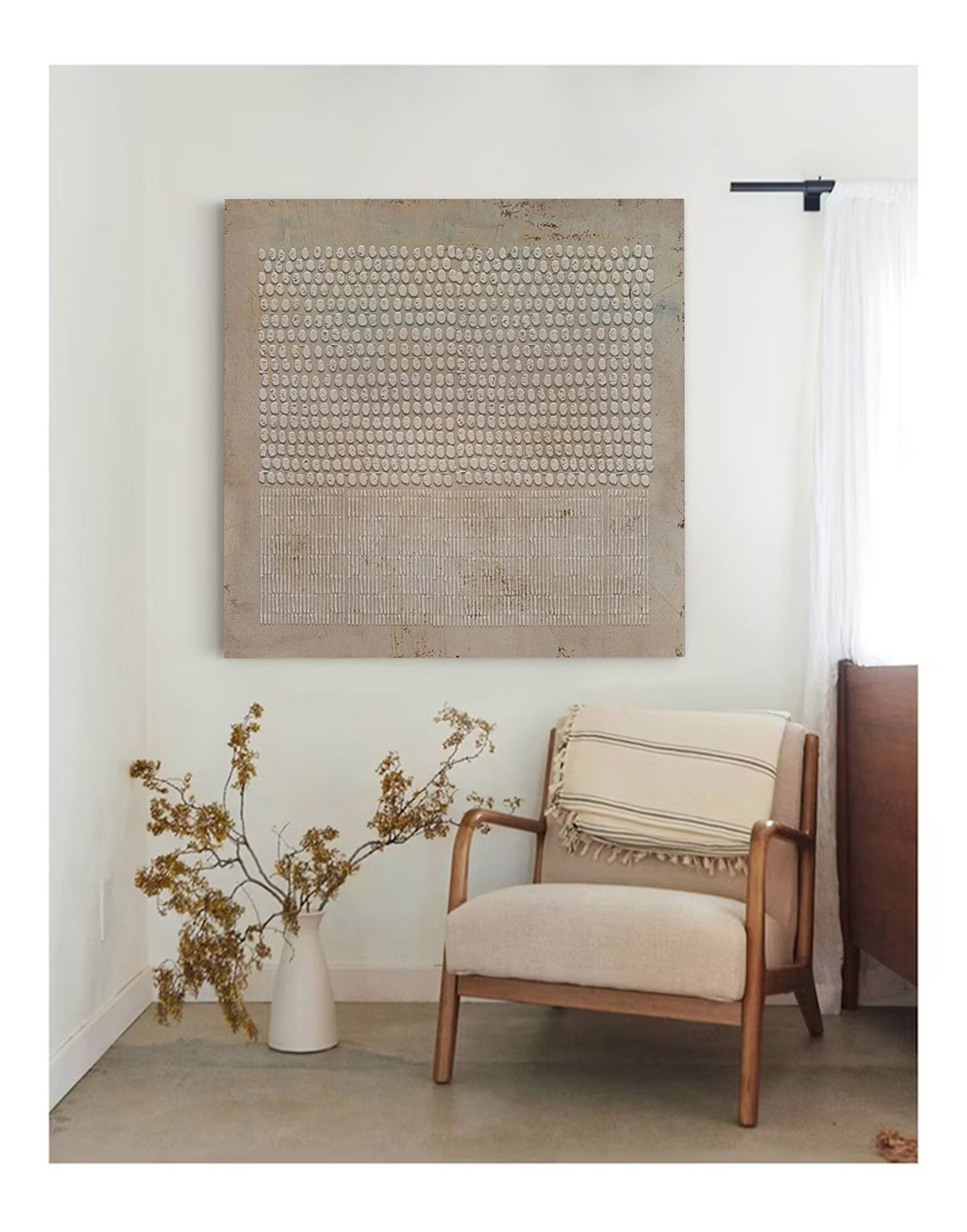 May include: A beige armchair with a white and black striped throw blanket sits in a room with a large abstract painting on the wall. The painting features a pattern of small white circles on a beige background.