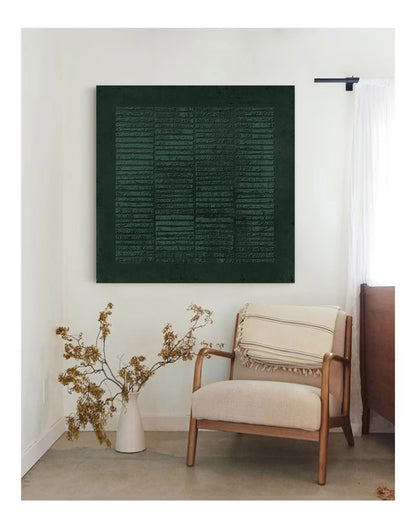 May include: A dark green abstract art print with a textured surface hangs on a white wall above a beige armchair with a striped throw pillow. A vase with dried branches sits on the floor in the corner of the room.
