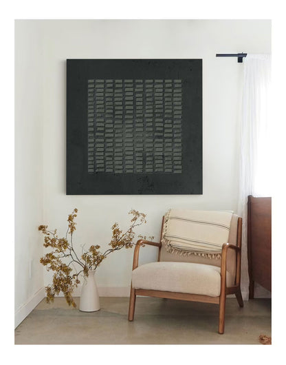 May include: A square wall art piece featuring a black background with a central grid of raised, rectangular gray textured elements. The artwork displays a matte finish and a repeating geometric pattern, creating a tactile surface appearance.