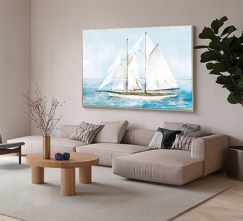 May include: A watercolor painting of a white sailboat with blue water and a light blue sky in the background. The painting is framed in a gold frame.