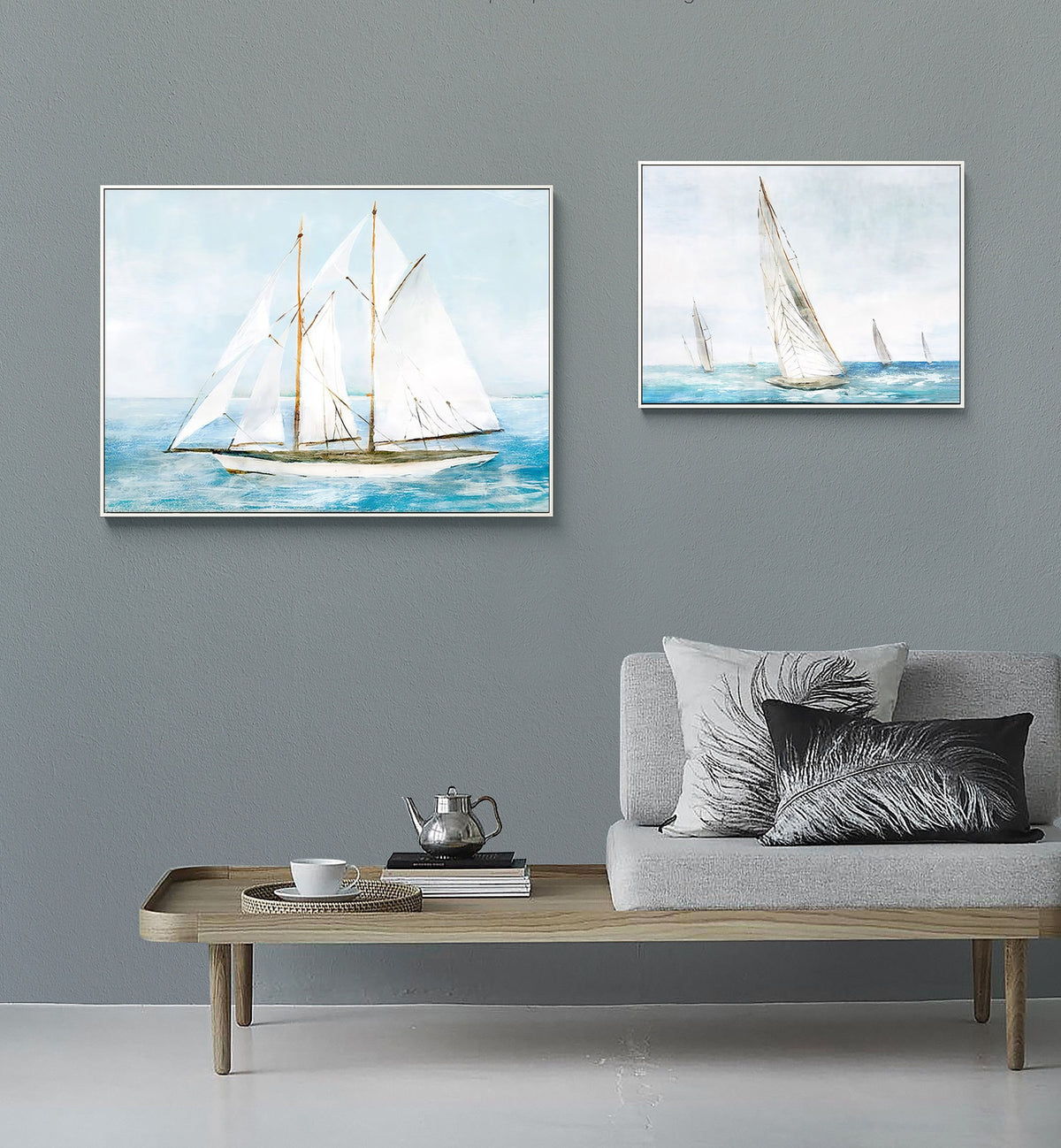 May include: Two framed watercolor paintings of sailboats on the water. The larger painting shows a single sailboat with white sails and a brown hull. The smaller painting shows three sailboats with white sails.