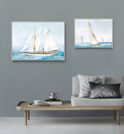 May include: Two framed watercolor paintings of sailboats on the water. The larger painting shows a single sailboat with white sails and a brown hull. The smaller painting shows three sailboats with white sails.