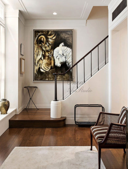 May include: A painting of a lion and a lamb with their heads touching. The lion is brown and has a mane. The lamb is white. The painting is on a canvas and is framed. The painting is hanging on a wall in a home.