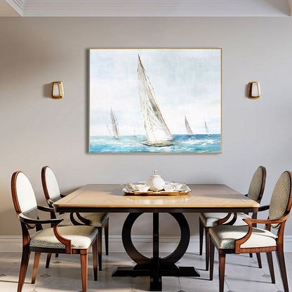 May include: A watercolor painting of sailboats on a blue sea with a light blue sky. The painting is framed in a gold frame and is hanging on a wall in a dining room.