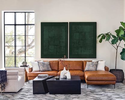 May include: A tan leather sectional sofa with a chaise, two black geometric coffee tables, and two large dark green rectangular wall art pieces with textured linear patterns, positioned in a room with a white patterned rug and a large potted plant.