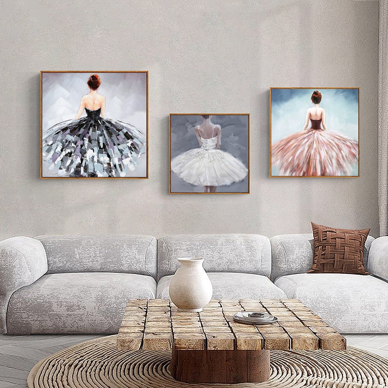 May include: Three framed paintings of ballerinas wearing tutus. The ballerinas are facing away from the viewer. The tutus are in shades of black, white, and pink.