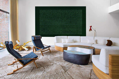 May include: A large rectangular wall art piece featuring a dark green background with a grid of light green dots above a section of vertical lines. The artwork is displayed in a living room with white sofas, blue chairs, and a textured rug.