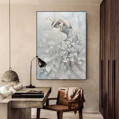 May include: An abstract painting of a dancer in a flowing gown adorned with white floral accents. The artwork features a muted color palette of gray, white, and blue, with the dancer's form gracefully arched. The painting is framed in black and hangs on a neutral-toned wall.