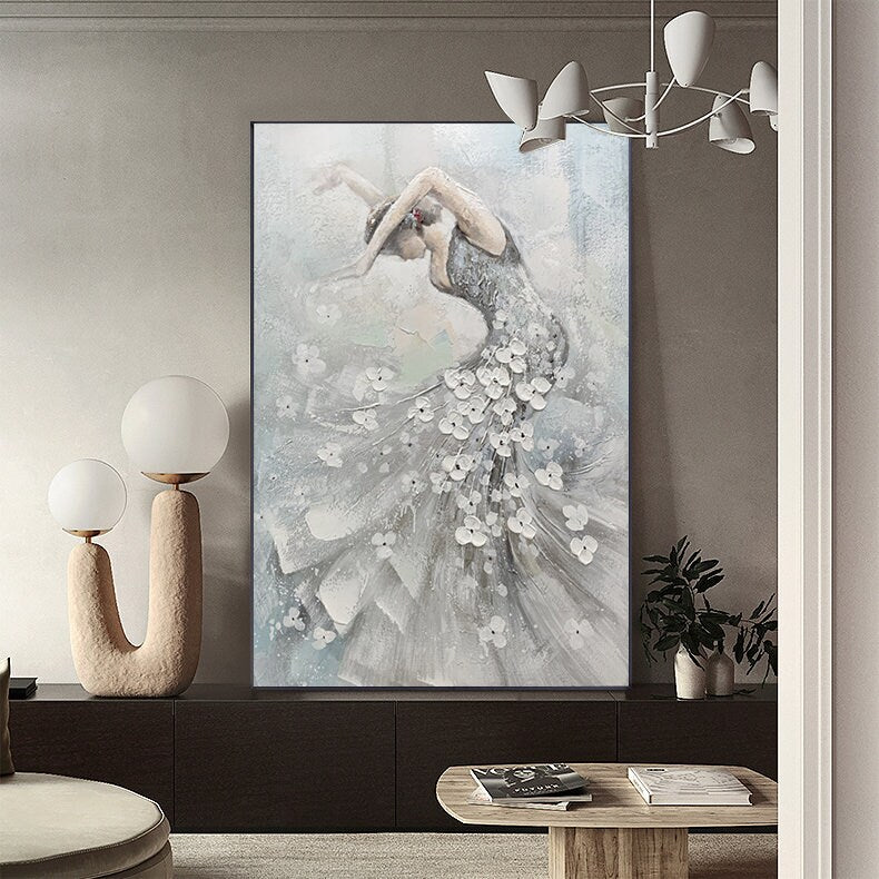 May include: An abstract painting of a ballerina in a flowing gown. The dancer is depicted in shades of gray and white, with white floral accents on the dress. The artwork has a textured, painterly style, evoking a sense of movement and grace.