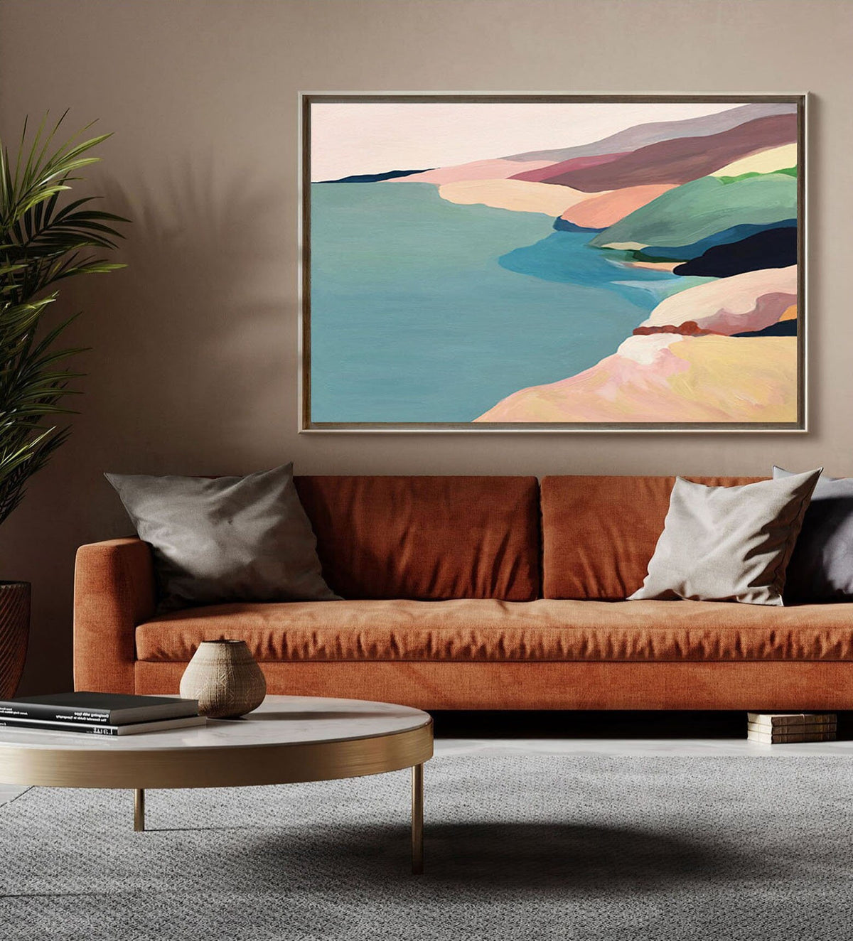 May include: Abstract landscape painting with a coastal scene. The painting features a blue body of water, a sandy beach, and a series of hills in shades of pink, green, and brown.