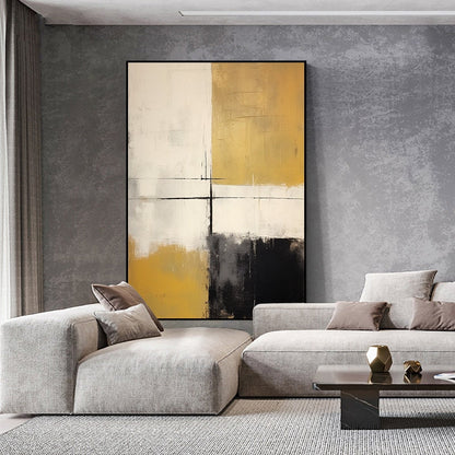 May include: Abstract painting with a white, black, and gold color scheme. The painting is divided into four sections, with each section featuring a different color. The painting is hanging on a gray wall in a living room setting.