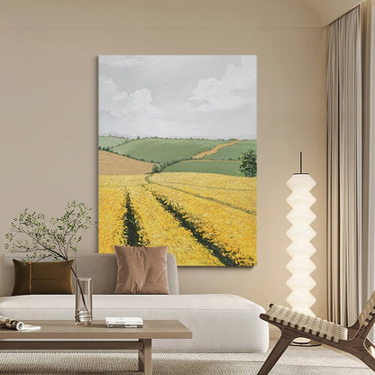 May include: A painting of a landscape with rolling green hills and a field of yellow wildflowers. The sky is cloudy and there is a path leading through the field.