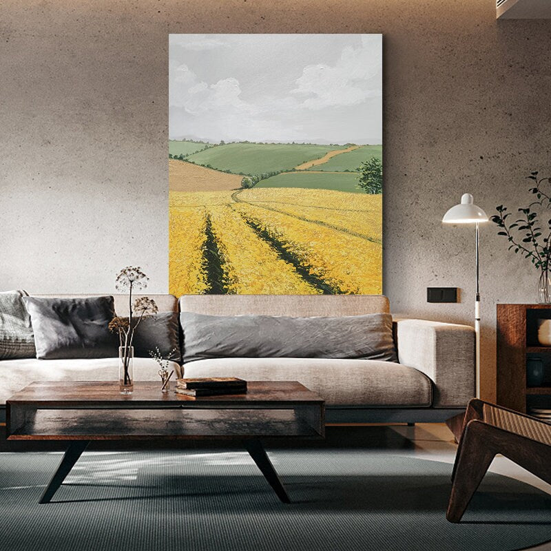 May include: A painting of a rural landscape with rolling green hills and a field of yellow wildflowers. The sky is blue with white clouds.