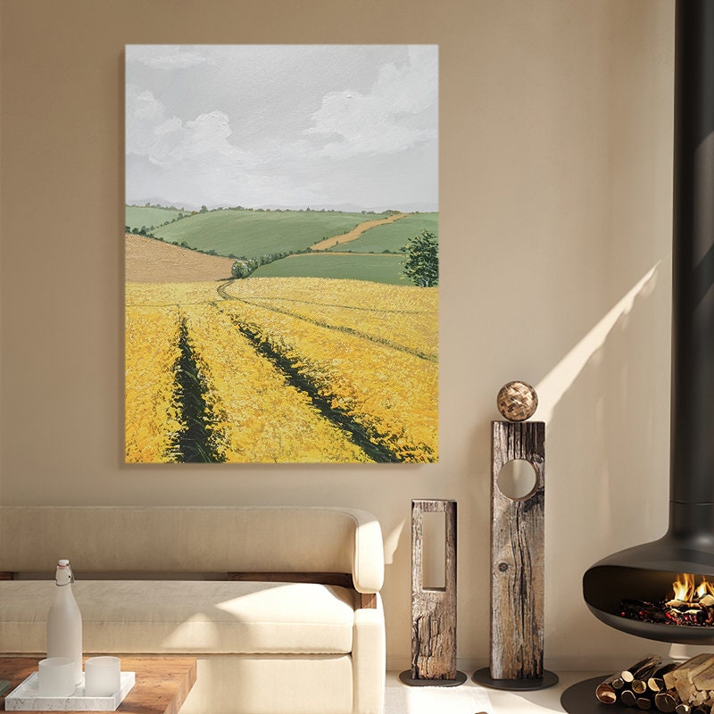 May include: A painting of a yellow field with rolling green hills in the background. The sky is a light blue with white clouds.
