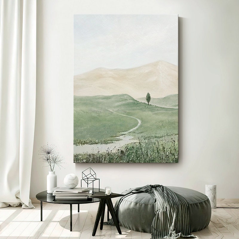 May include: A painting of a green grassy field with a winding dirt path leading to a lone tree on a hill. The sky is a soft blue with white clouds.