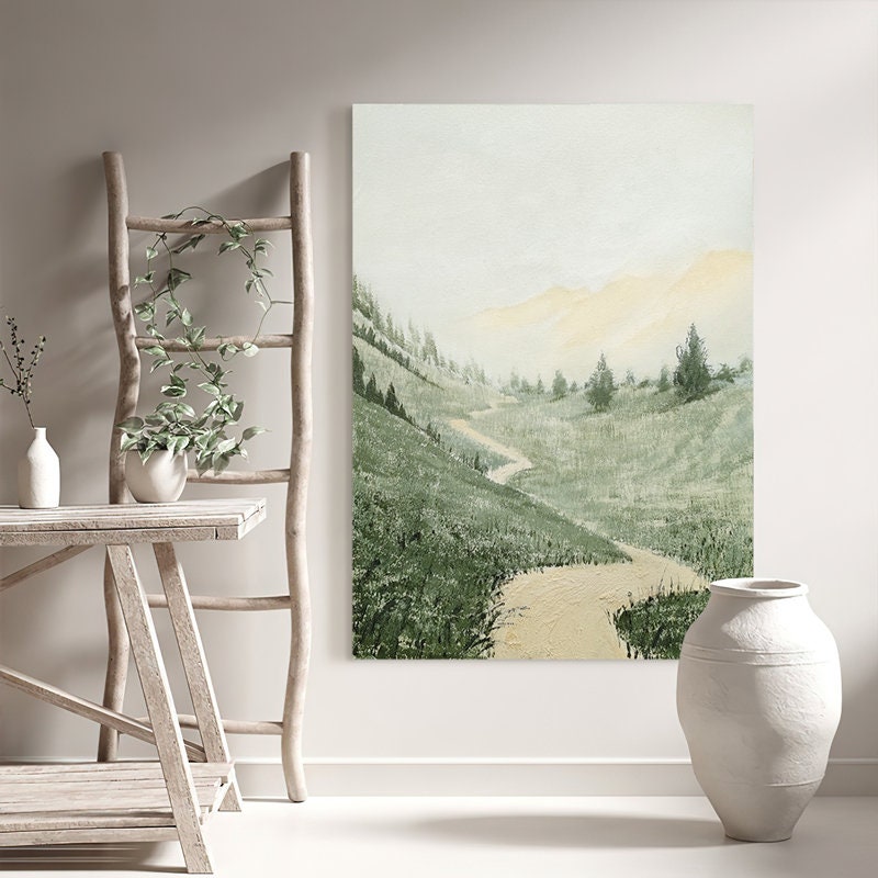 May include: A watercolor painting of a winding path through a green grassy valley with a misty background. The path leads to a distant mountain range with a yellow glow.