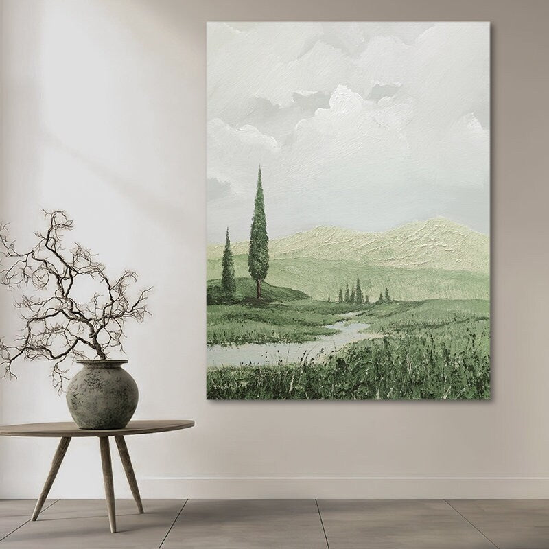 May include: A painting of a green landscape with a river winding through it. There are trees on the hills in the background and a cloudy sky.