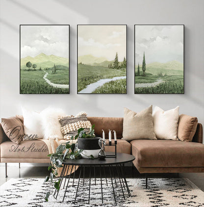 May include: Three framed landscape paintings with a green and white color scheme. The paintings depict a winding path through a grassy field with trees and mountains in the background.
