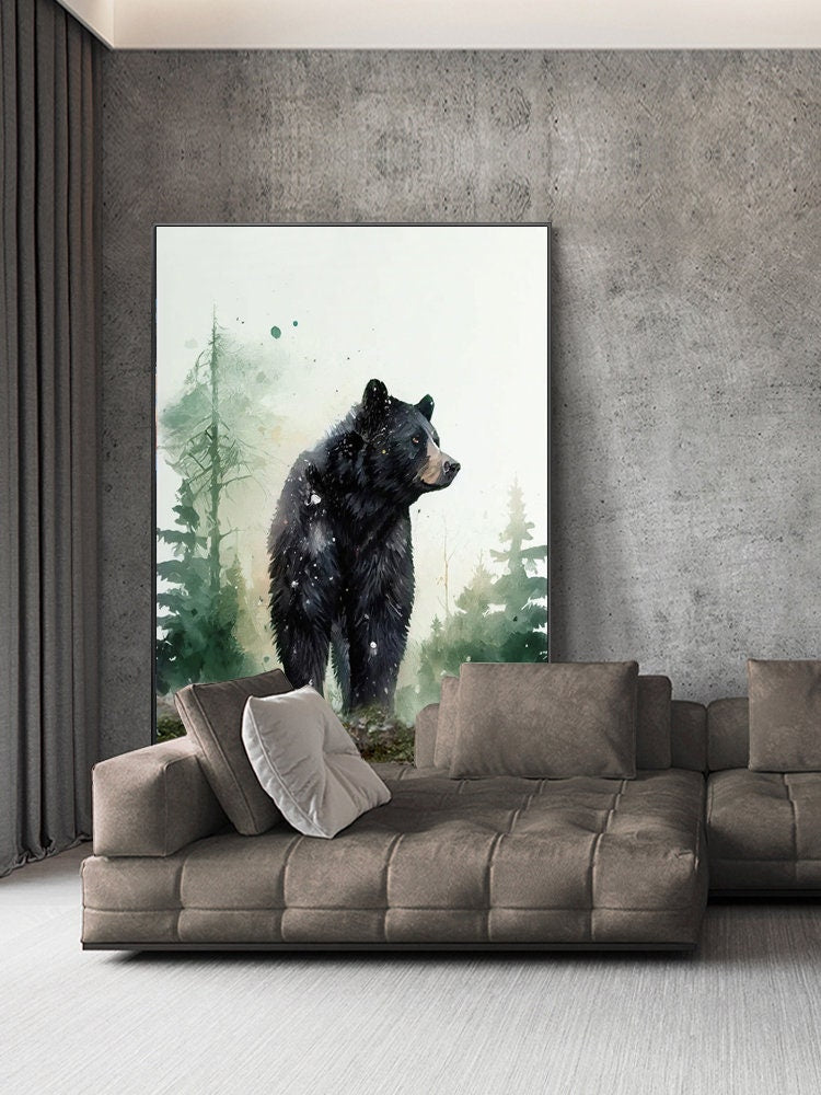 May include: A watercolor painting of a black bear standing in a forest setting. The bear is facing to the right and is surrounded by green trees and foliage. The painting is framed and hanging on a wall above a brown sectional sofa.
