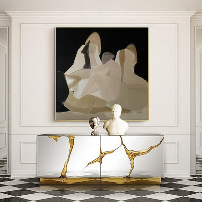 May include: A gold and silver console table with a unique, abstract design. The table has two doors and is decorated with gold accents. The table is in front of a white wall with a large abstract painting of figures in shades of brown and black.