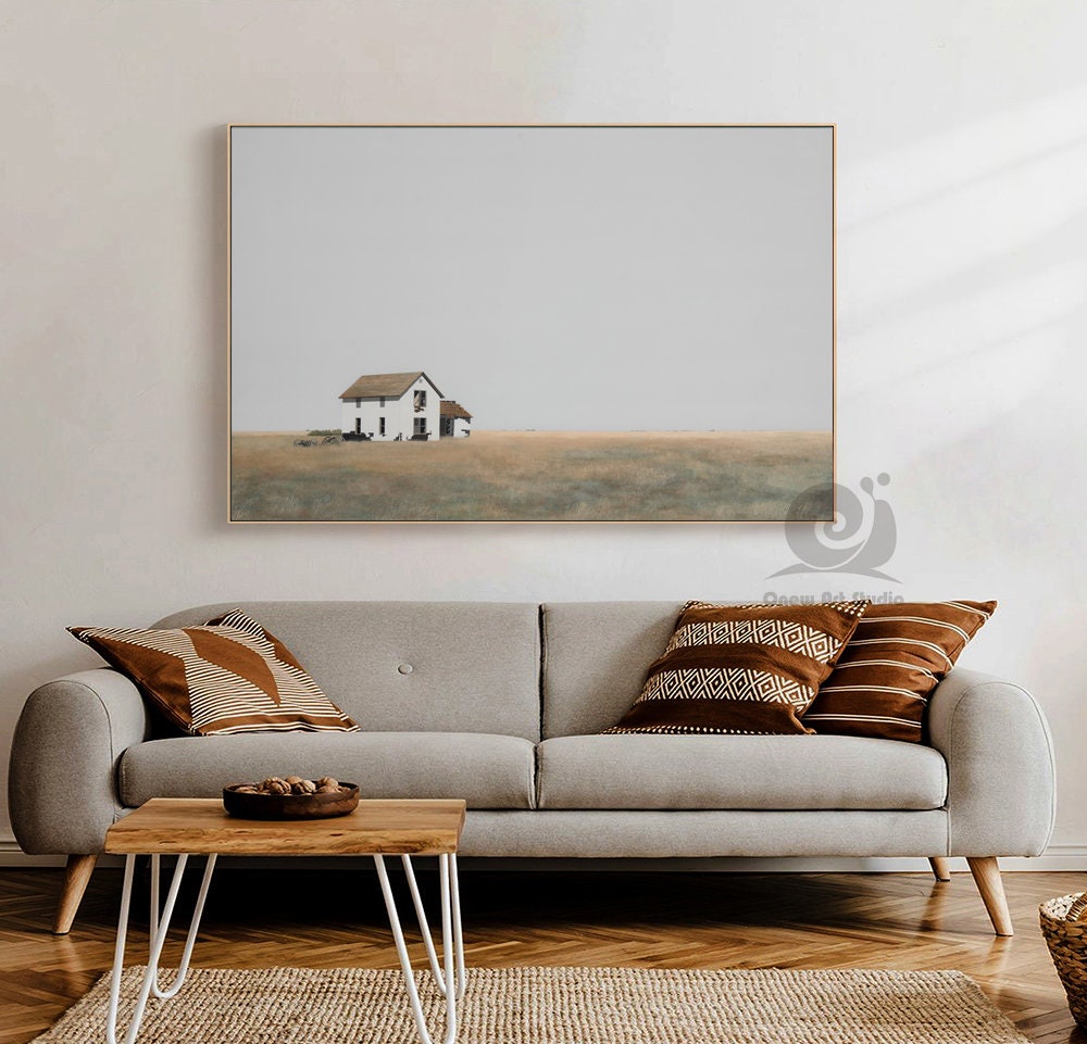 May include: A minimalist painting of a white farmhouse with a brown roof in a field of tall grass. The sky is a light gray, and the farmhouse is the only structure in the image.