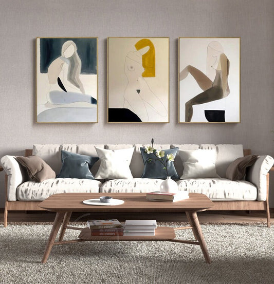 May include: Three abstract paintings of figures in muted colors with gold frames. The figures are in various poses and are painted in a minimalist style.