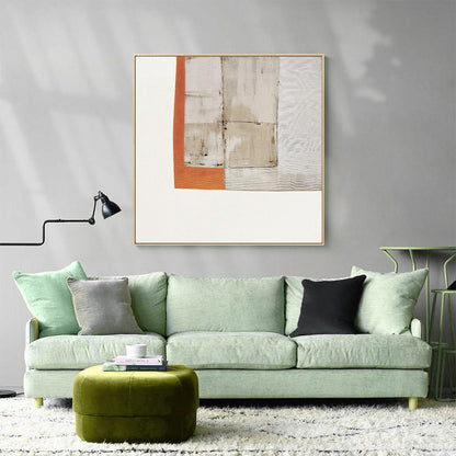 May include: A green sofa with three pillows, a green ottoman, and a framed abstract painting with orange, white, and brown geometric shapes.