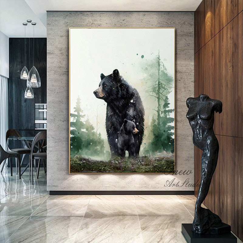 May include: A watercolor painting of a black bear and her cub standing in a forest. The painting has a soft, dreamy feel and is framed in a gold frame.